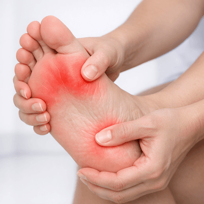 Patient holding a painful foot and big toe