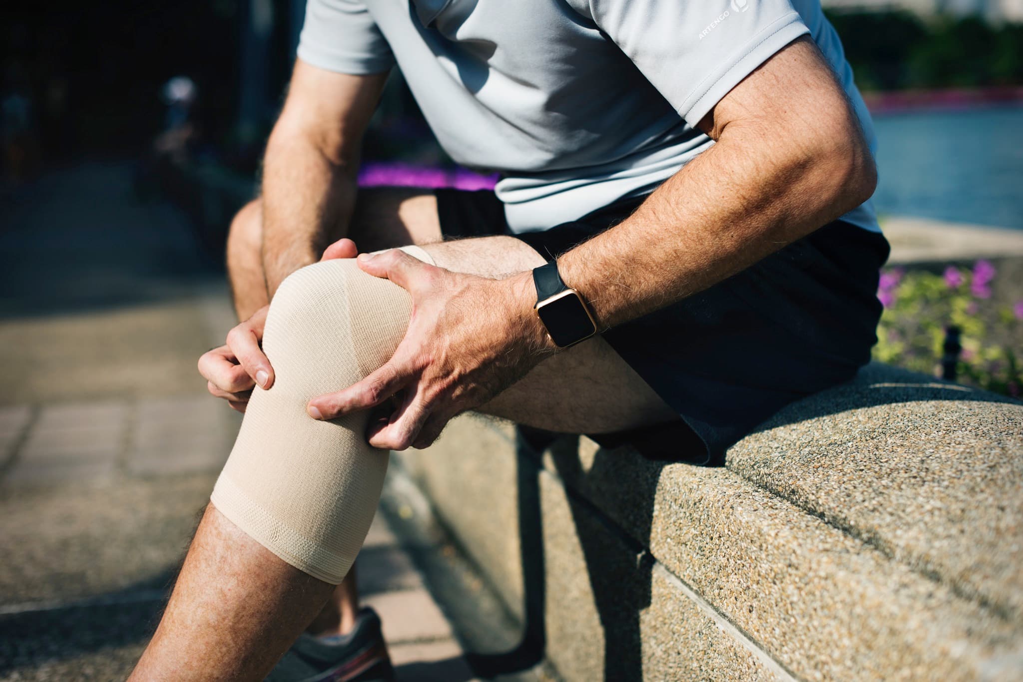 Consultant demonstrating knee implant model in clinic